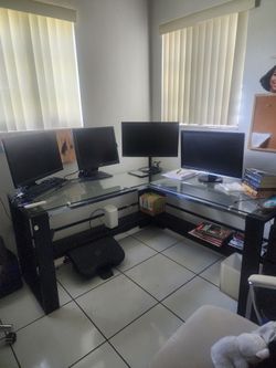 L shaped desk, 3 office chairs. 4 monitors.