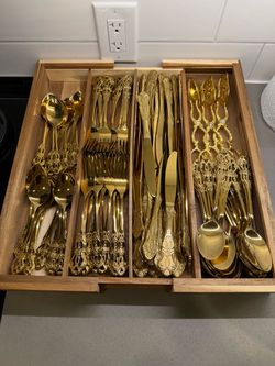 40 settings of gold flatware