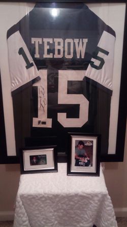 Authintic hand sighned Tim tebow custom framed jersey with certificate of authinticity and picture of sighning