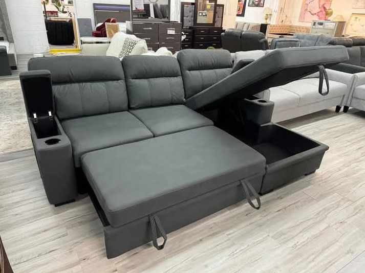 Black fabric sleeper sectional sofa chaise with storage arm and cup holder 
