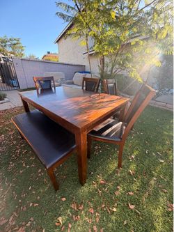 Table and chairs with bench