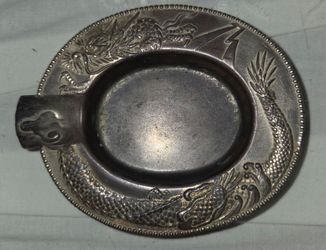 Vintage silver‑plated dragon cigarette ashtray. Embossed dragon design. Measures four inches long by three and a half inches wide. Good vintage condit