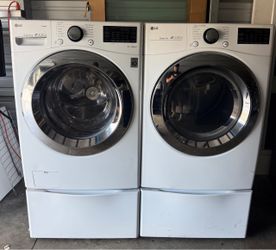 LG front-loading washer and dryer with pedestals