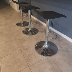 Black And Silver Height Adjustable Swivel Bar Stools.