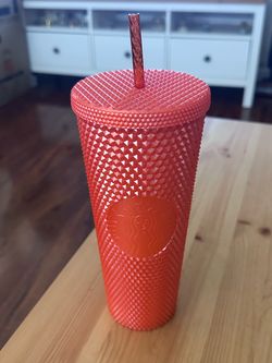 Orange studded Starbucks tumbler