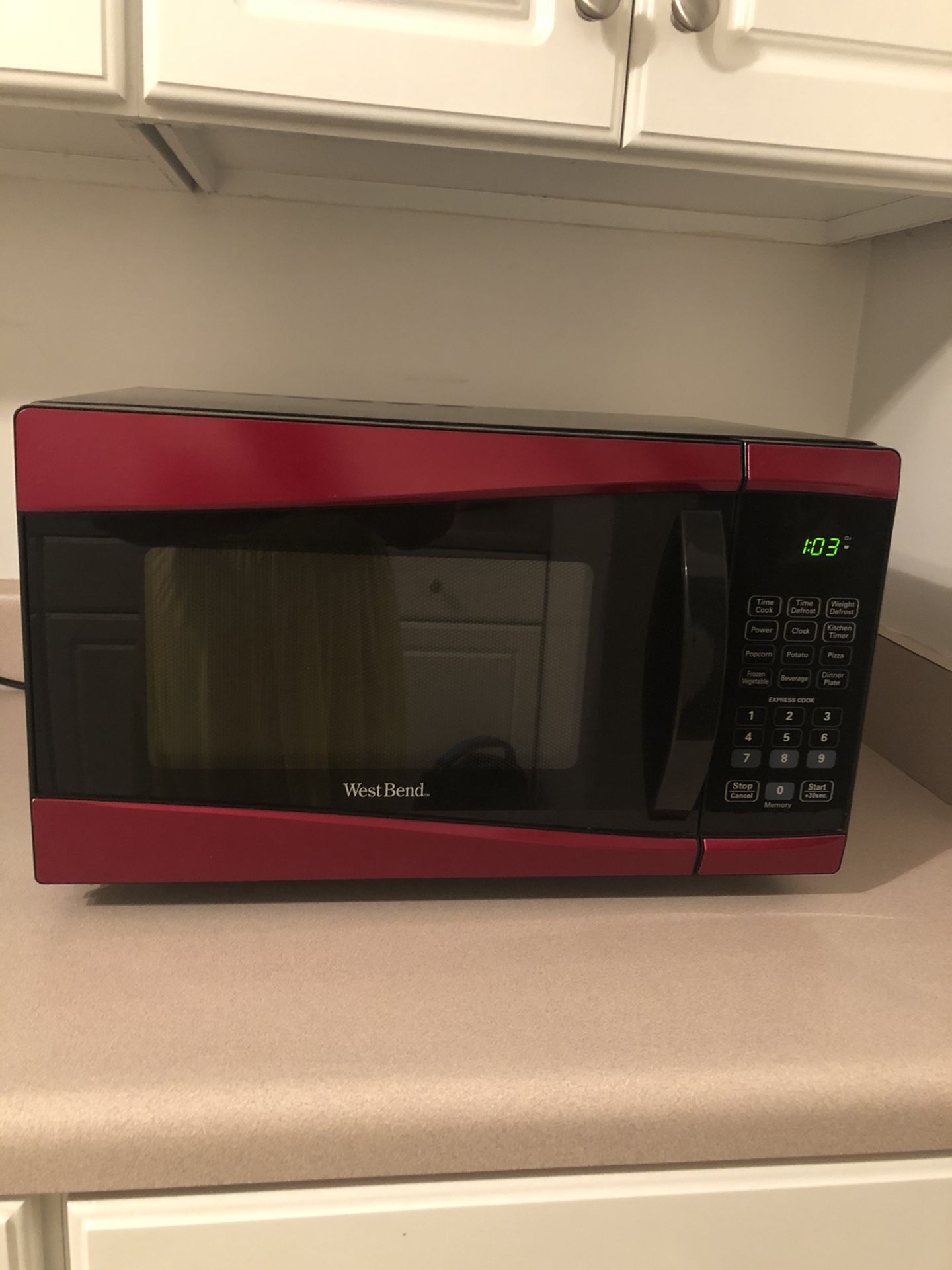 Used WestBend red 900 watts microwave