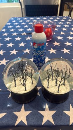 2 Snow globes and a can of snow