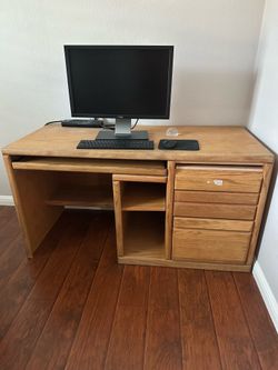 light oak wood computer desk features a pull-out keyboard tray office