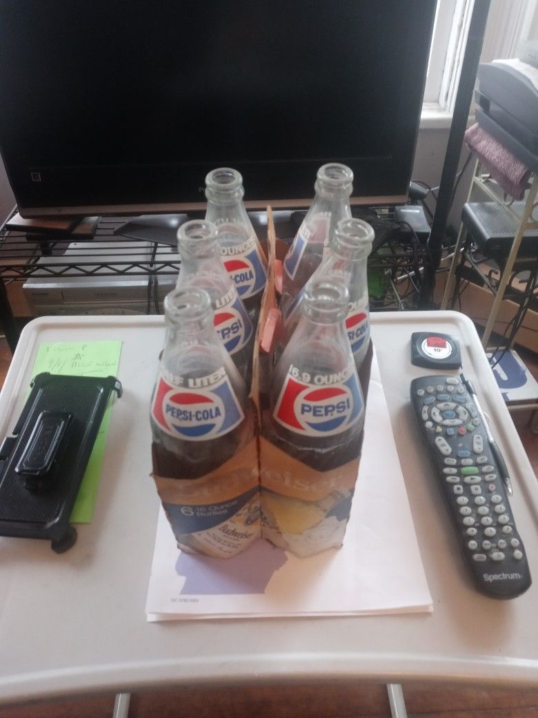 Six Pepsi-Cola Bottles