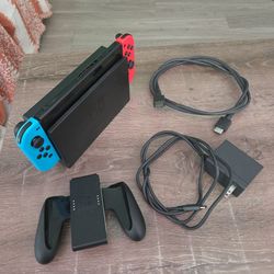 Nintendo Switch black, pink and blue controllers with cords and dock