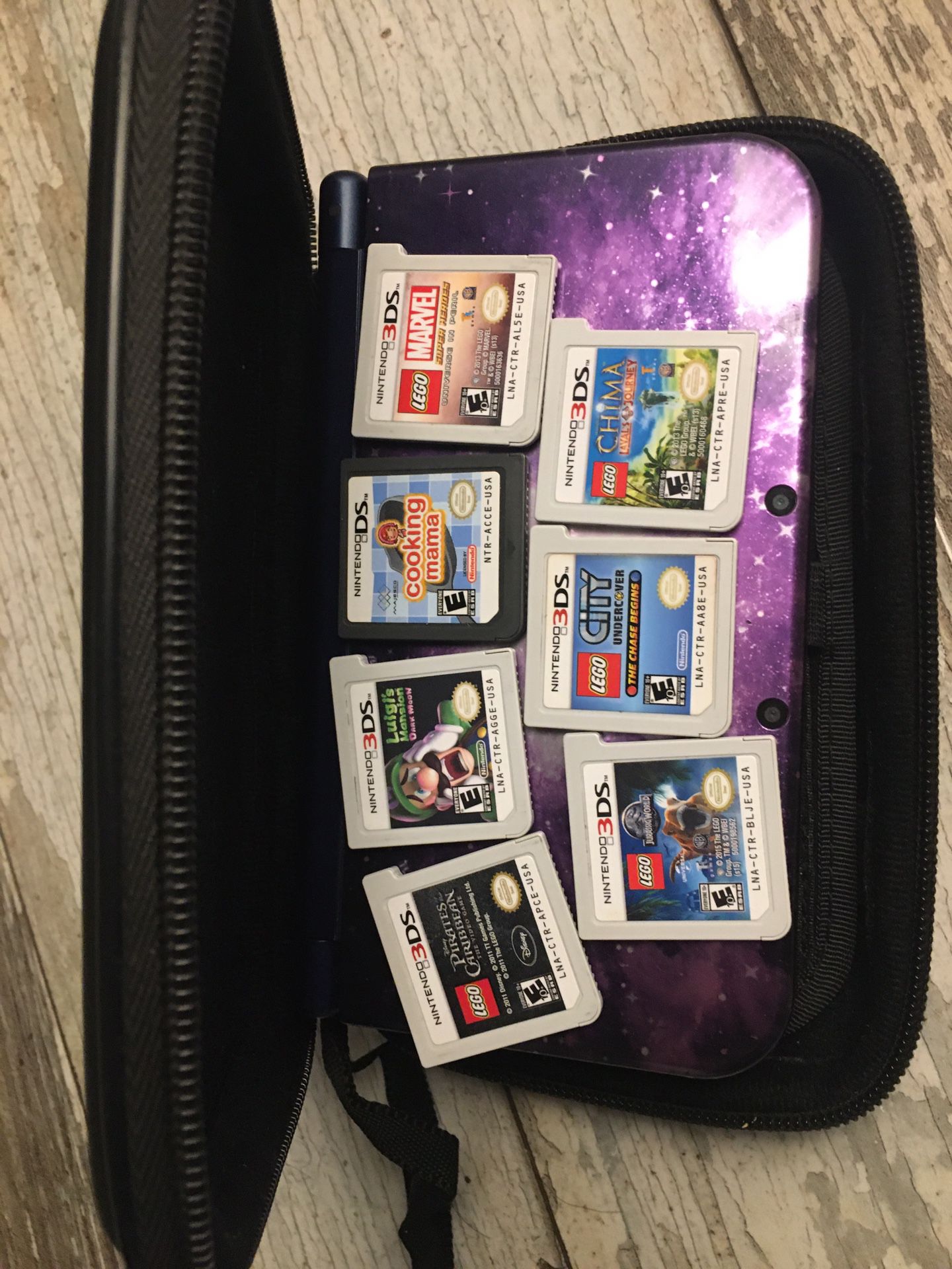 Nintendo 3DS XL galaxy with protective case and 7 games