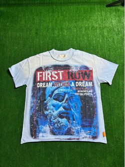 First row, blue designer shirt