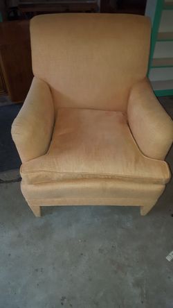 it isan orange sofa chair with detachable cushion