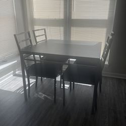 Black and silver four seater dining room table