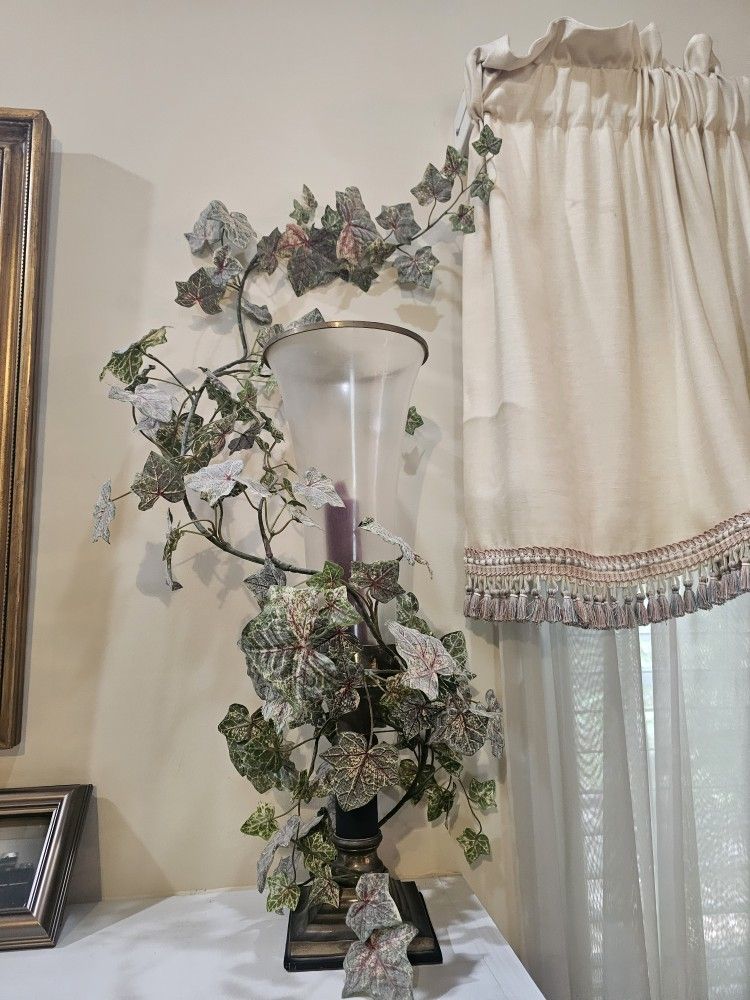 Candles with flower around the glass