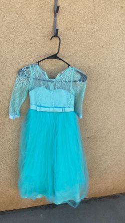 Cute teal, bluish dress ready to find a home