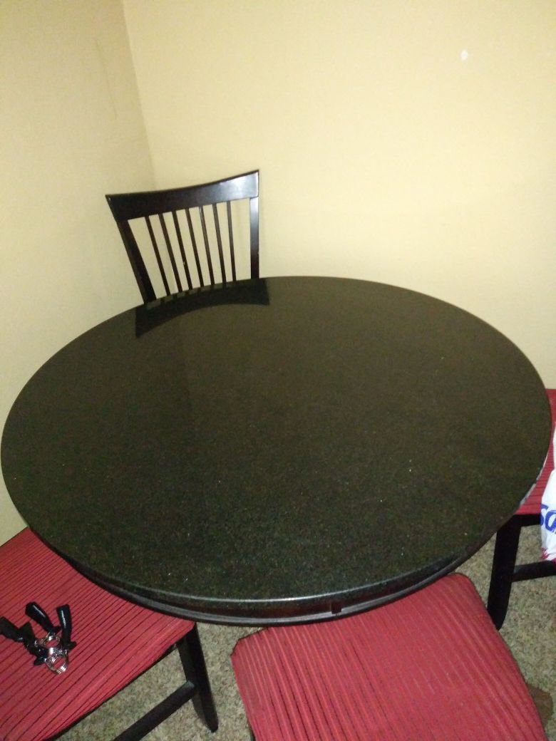Solid black marble tabe with 4 black and red chairs(if you want the chairs).