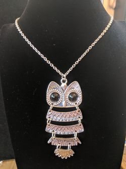 $10. Silvertone articulated owl necklace with black eyes. Necklace is 30 in. Pendant is 3.5 in long and 1.5 in wide.