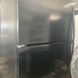 Black Top And Bottom Refrigerator Made By Whirlpool  