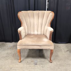 Tan Upholstered Shell Back Armchair with Carved Wood