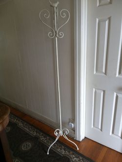 Antique jacket hanger with little Birdy on top