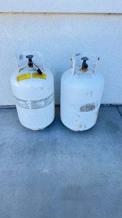 (2) tall 7.5 gal propane tanks. Expired