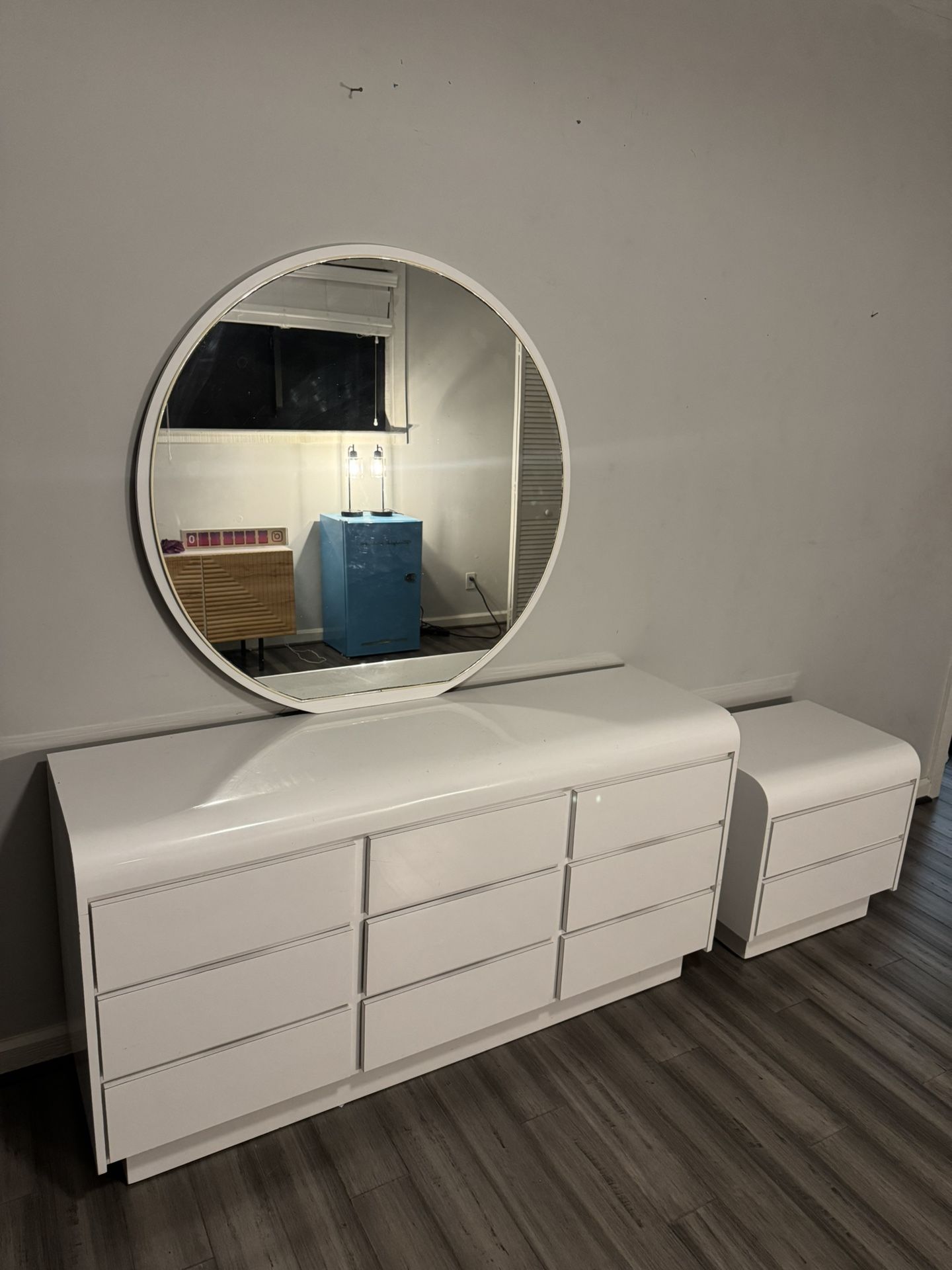 White Modern Dresser With Big Circular Mirror And Bedside Nightstand