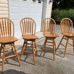 Set of four oak wood swivel barstools