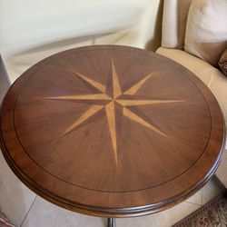 Ethan Allen Country French tea table featuring a compass star inlay top and a metal base