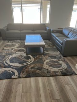 Elegant, gray, adjustable leather couch  and love seat for a living room