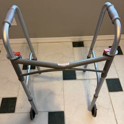 Sturdy folding walker with two 5 inch wheels for easy mobility.