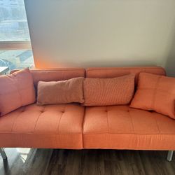 Orange Futon couch - Lays Down As Bed 