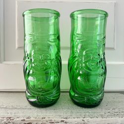  Set of 2 green glass lucky Buddha beer bottle glasses They are 7” Tall. They are 2 7/8” across the tops.  They hold 16 ounces. 
