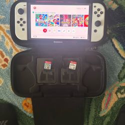 Nintendo Switch OLED with games, controllers, cases, memory card