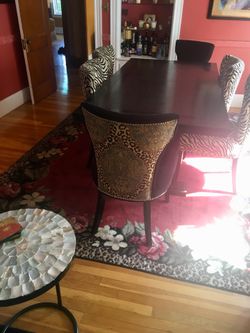 2 chairs black front and animal print back
