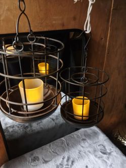 Two metal hanging candle holders