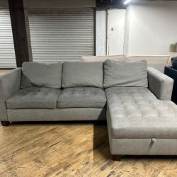 Delivery available gray sectional couch and storage