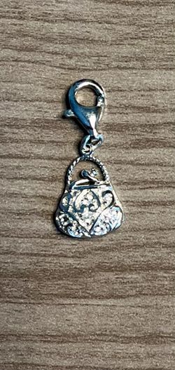 Sparkling silver-stamped 925 purse charm with rhinestone accents. Lobster clasp for easy attachment. Elegant filigree detailing. Great for necklaces,
