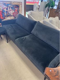 West Elm Andes style sofa in a dark velvet fabric with cast metal legs
