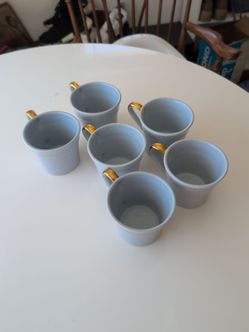 Blue coffee mugs with metallic plating on handle