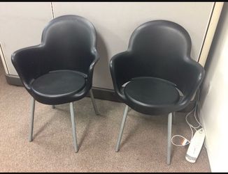 2 modern black plastic chairs