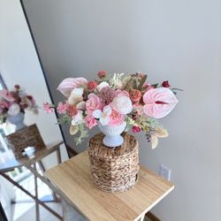 Pastel bouquet with anthuriums, roses and decorative flowers in a ceramic vase 