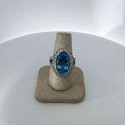 14K yellow gold lady’s 11.67 center blue topaz and 1.26CTW of diamonds 