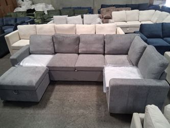 Light gray sectional sofa with pull-out bed and ottoman storage