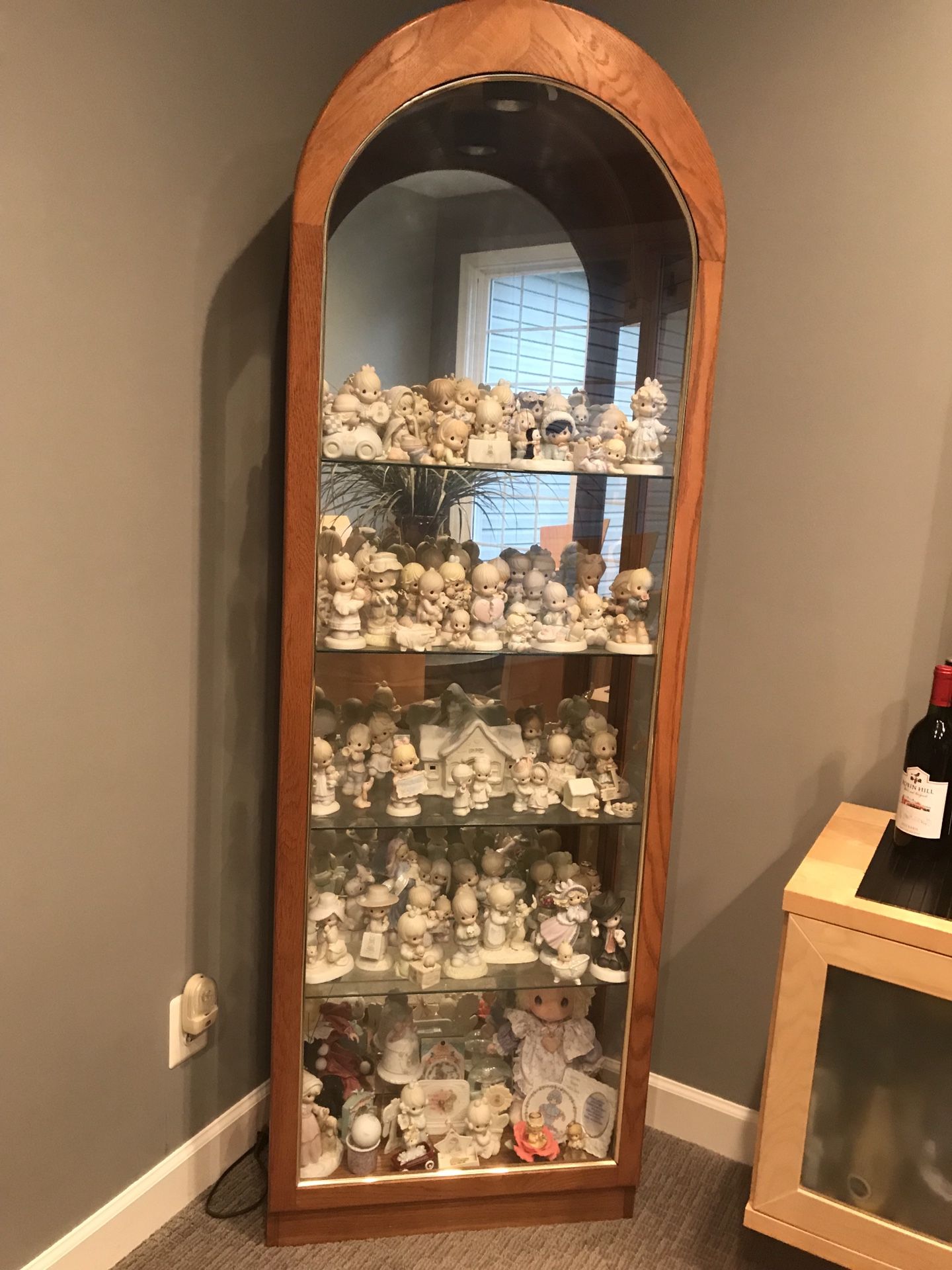 Precious Moments figurines and cabinet