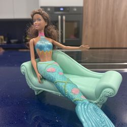 Mermaid Barbie doll in her sofa