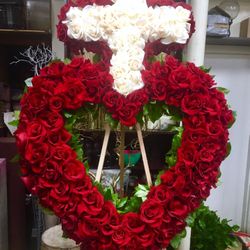 Funeral arrangements any color made with fresh flowers.