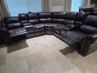 Dark brown sectional with dual power recliners.