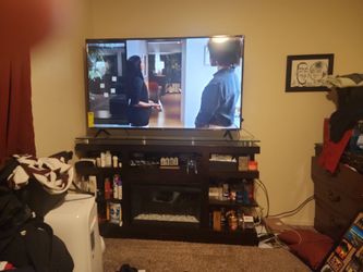 65 Inch Roku Smart TV With Fireplace Stand