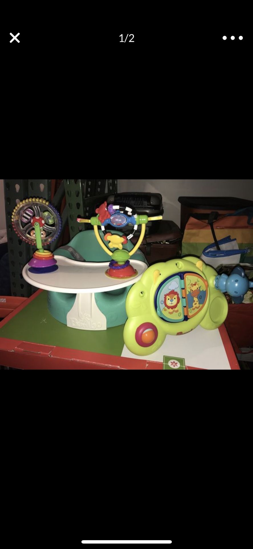 Bumbo seat with tray and toys .